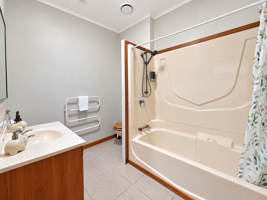 Main bathroom with shower over the bath