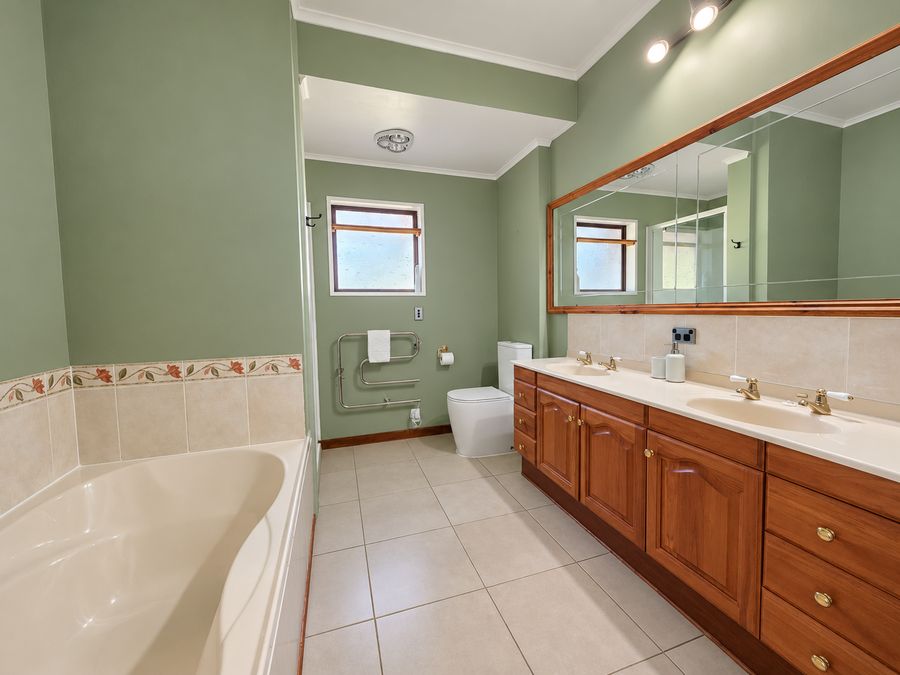 Green ensuite with double vanity and bath