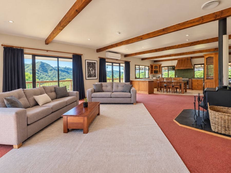 Open-plan lounge looking through to the kitchen and the hills